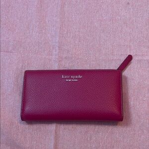 kate spade burgundy wallet with zip-around closure and textured leather